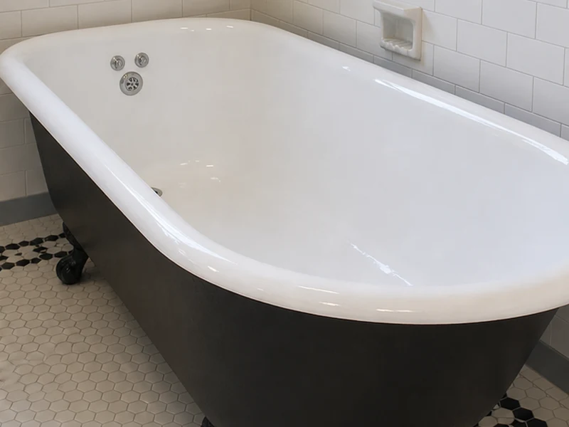Restored clawfoot tub with bright white interior and black exterior in an Old Quad home, Santa Clara
