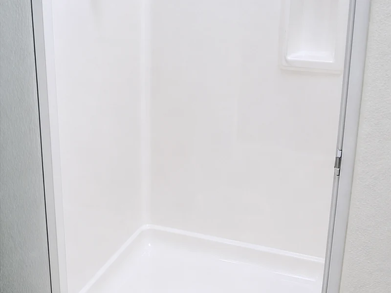 Fiberglass shower stall after refinishing, uniform glossy white surface, Lawrence Station condo, Santa Clara