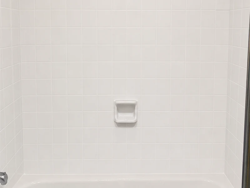 Tub-surround tile after reglazing in bright white with clean grout lines, Forest Park home, Santa Clara